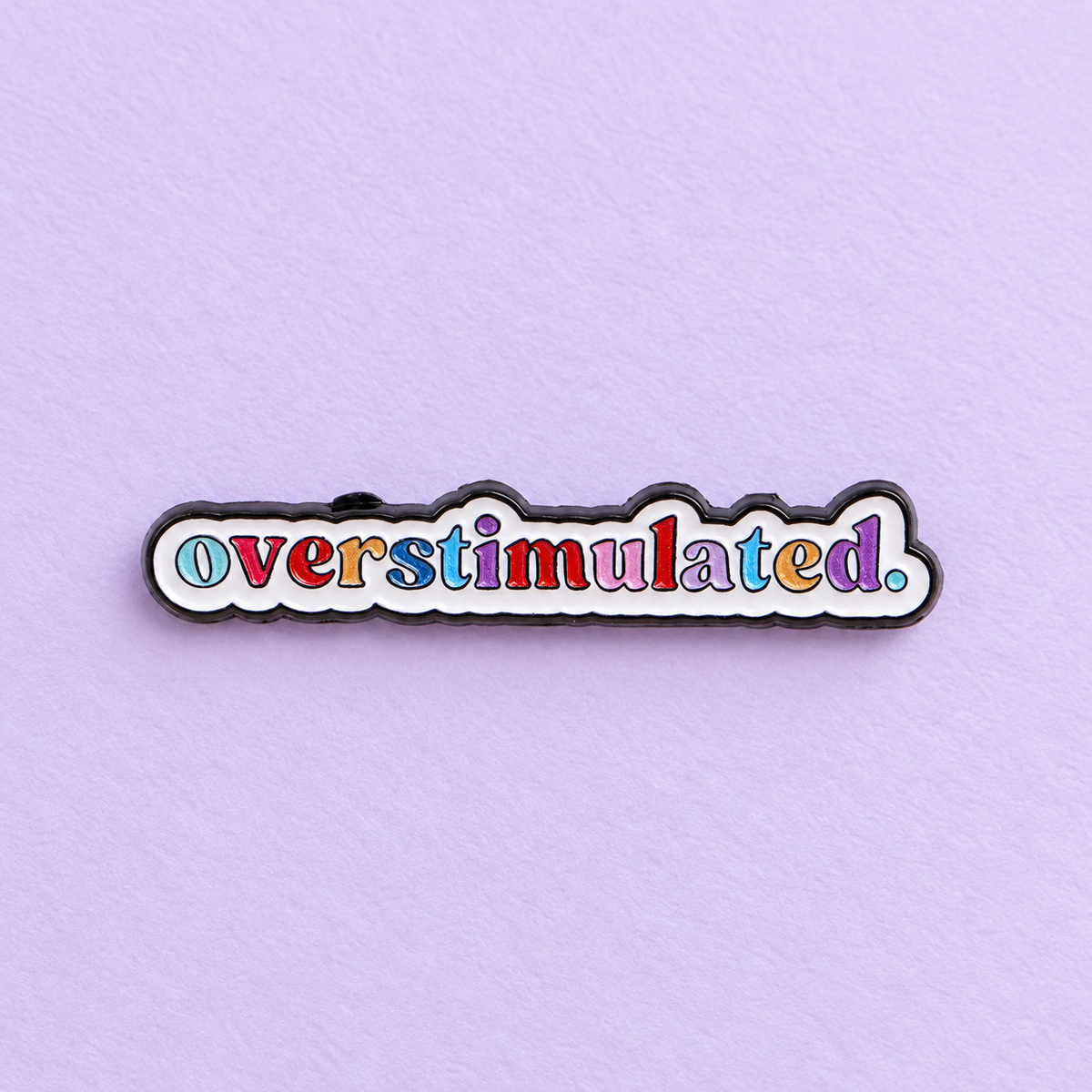Overstimulated Colourful Lettering Pin on lavender paper