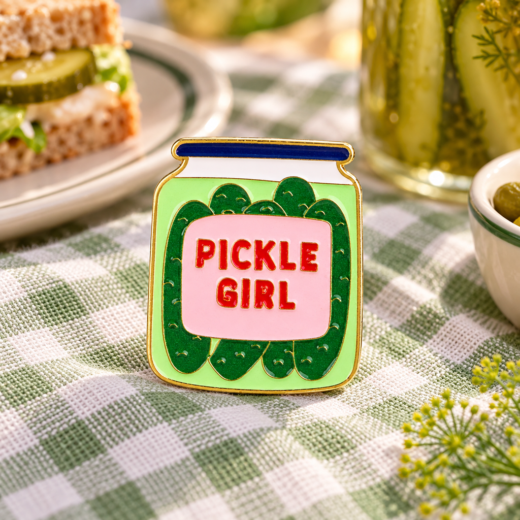 Pickle Girl jar enamel pin on gingham kitchen linen