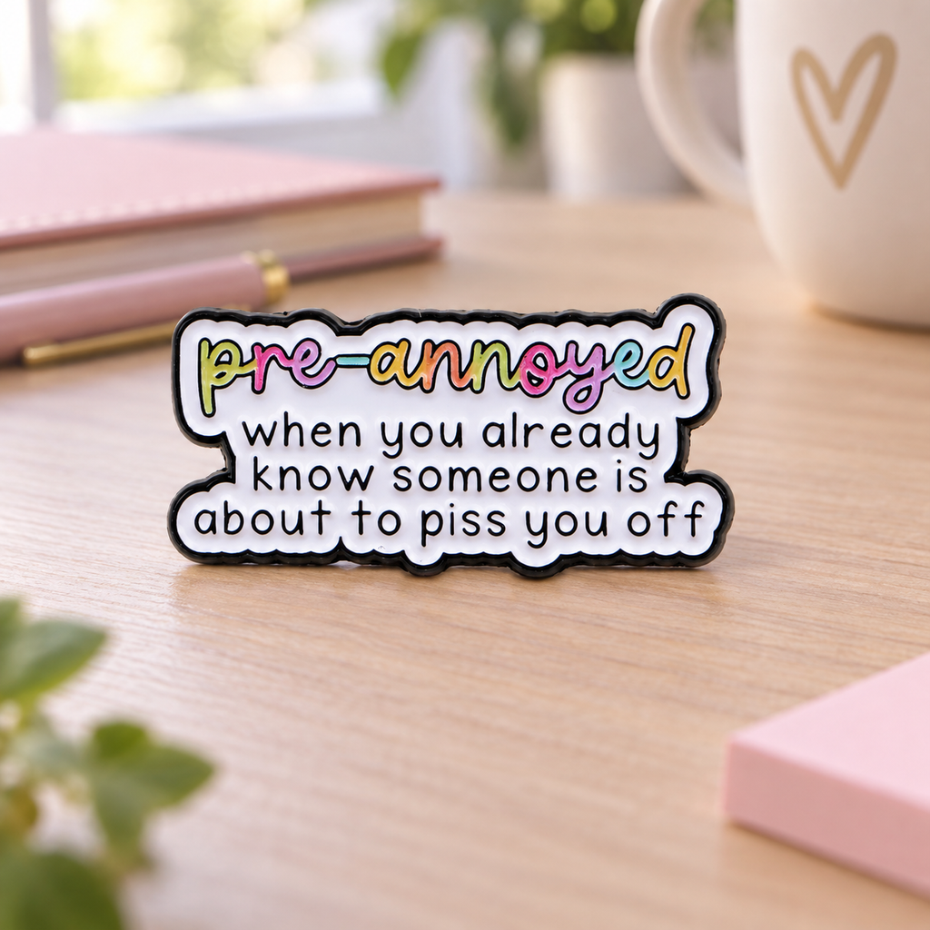 Pre-Annoyed Pin on a pastel office desk