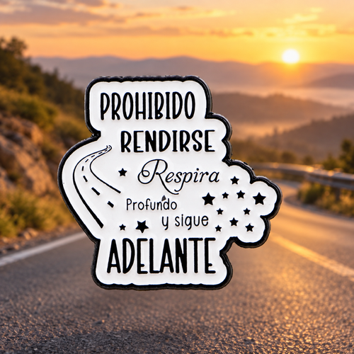 Prohibido Rendirse Keep Going enamel pin on a hopeful sunrise road