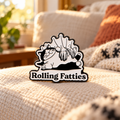 Rolling Fatties Cat Pin on a cozy living room blanket