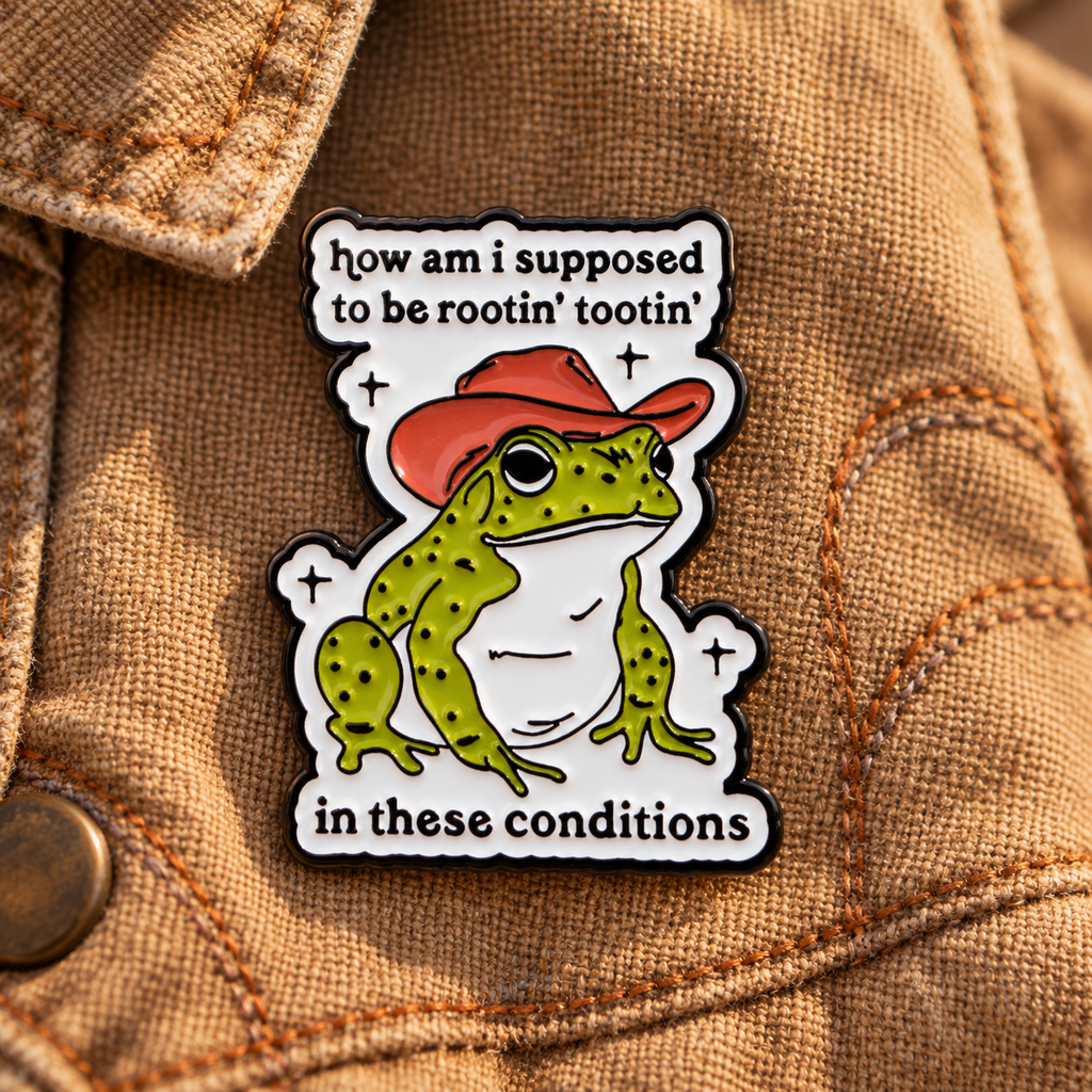 Rootin Tootin cowboy toad enamel pin on tan canvas