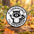 If I Shenan Once I'll Shenanigan raccoon enamel pin in an autumn woodland
