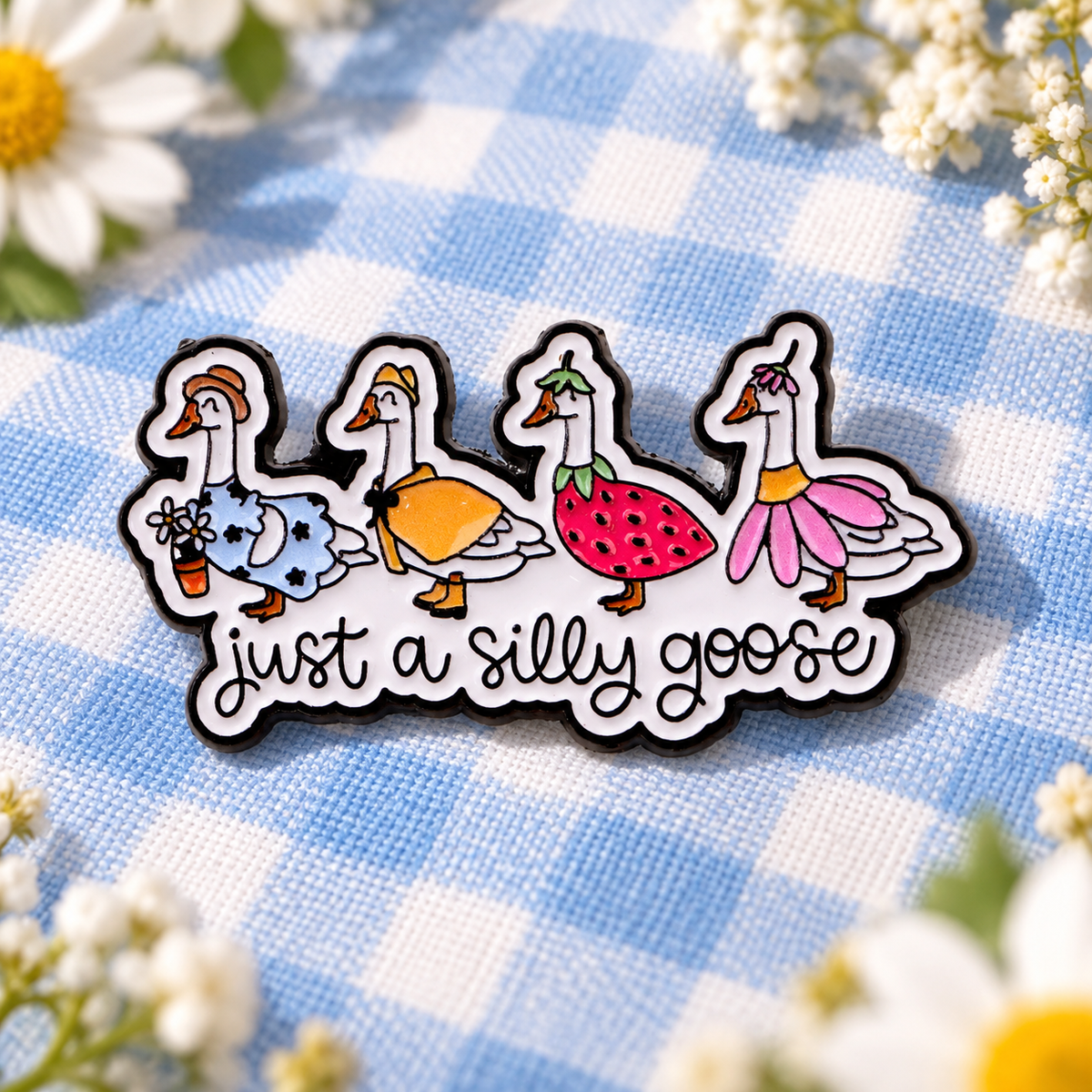Just A Silly Goose Pin on pale blue picnic cloth