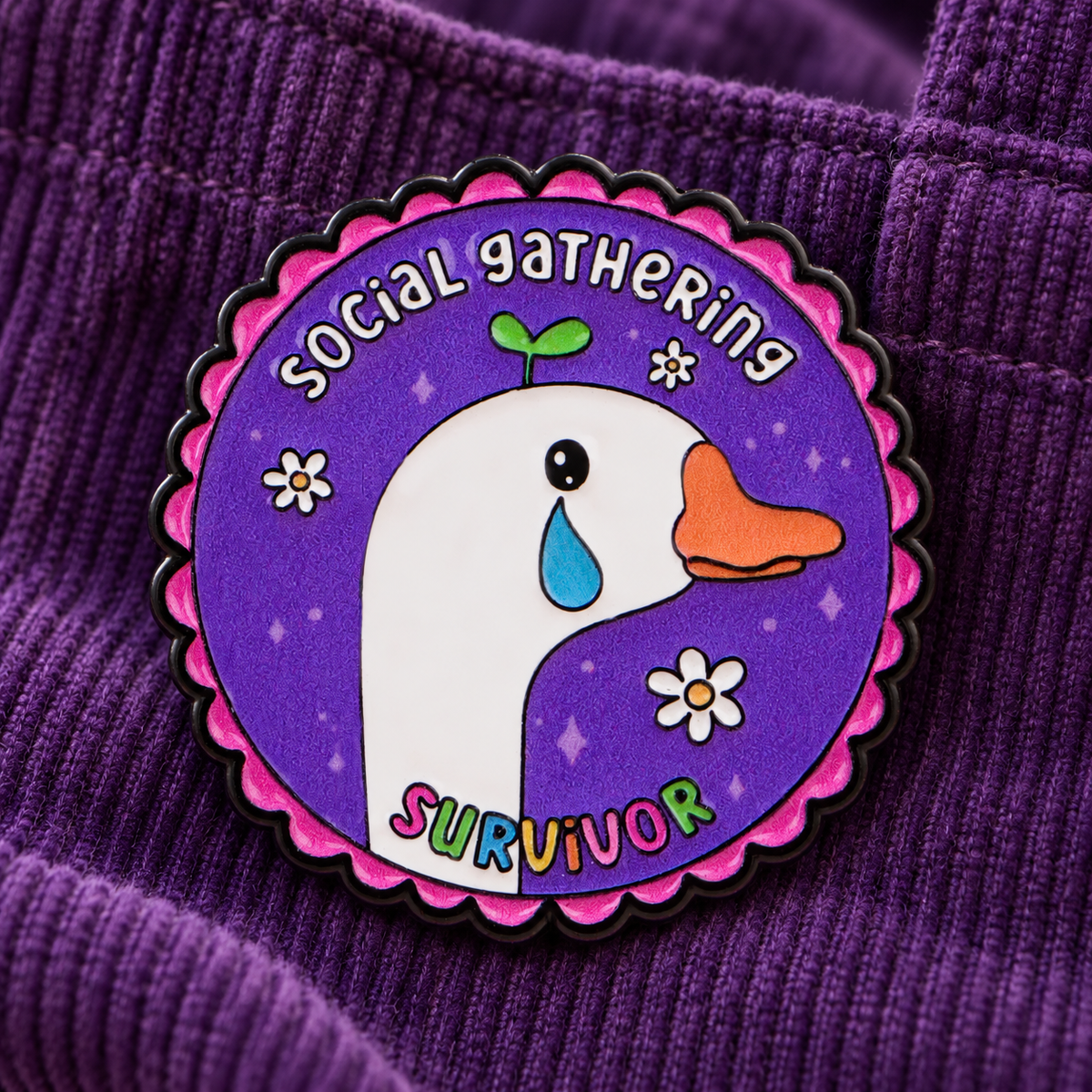 Social Gathering Survivor goose enamel pin on purple corduroy