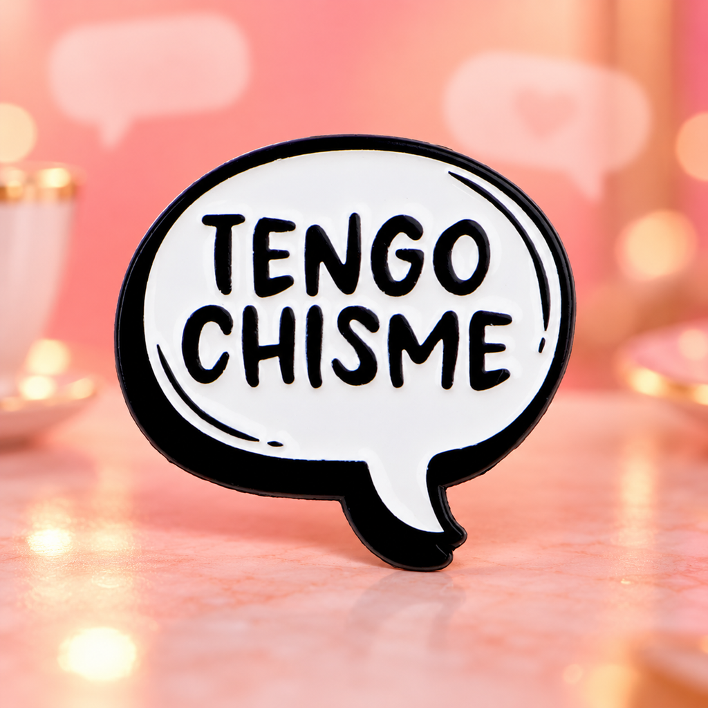 Tengo Chisme speech-bubble enamel pin on a warm coral chat-themed background