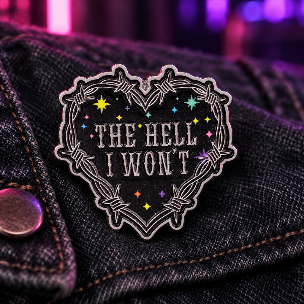 The Hell I Won't heart enamel pin on dark denim with neon light