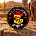 This Is My Second Rodeo duck enamel pin in a western ranch setting