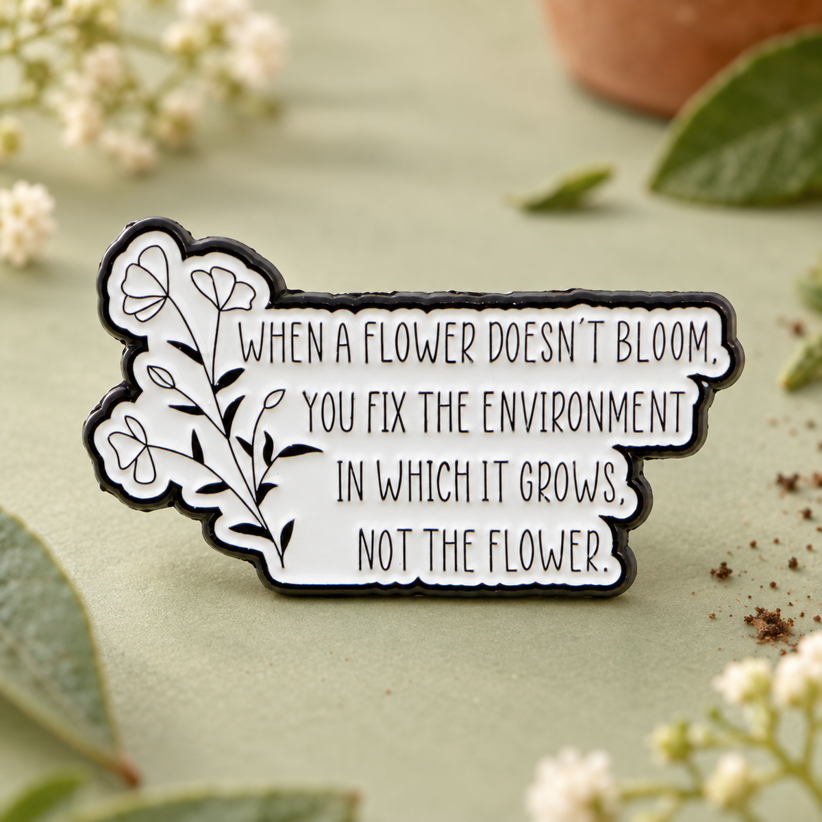 When a flower doesn't bloom autism pin on a pale sage garden tabletop