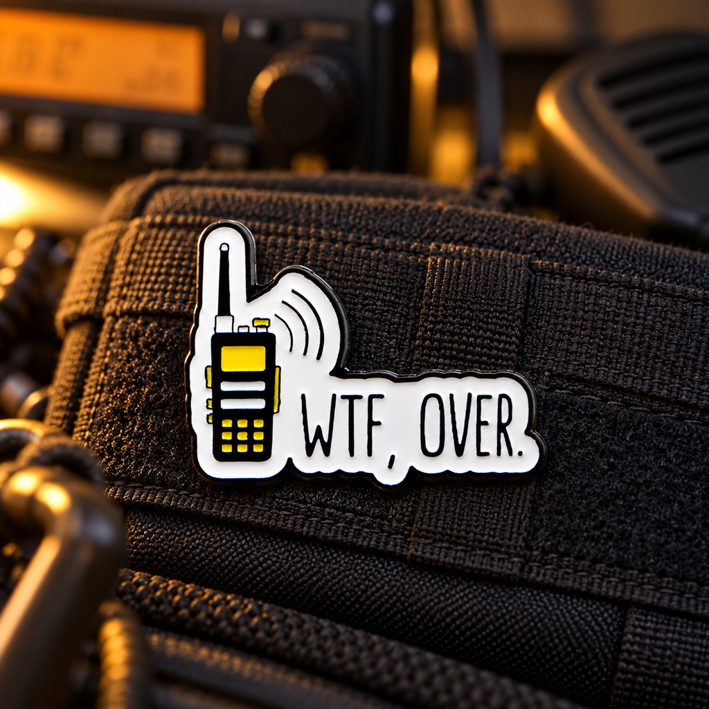WTF, Over phone enamel pin on dark tactical fabric