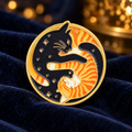 Black and Orange Yin Yang Cats enamel pin on midnight-blue velvet