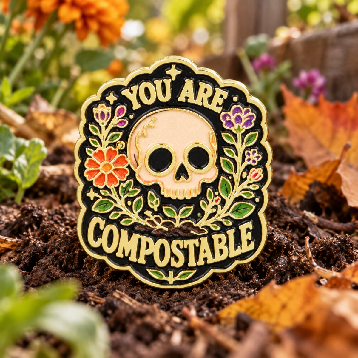 You Are Compostable Skull Pin enamel pin on a themed background