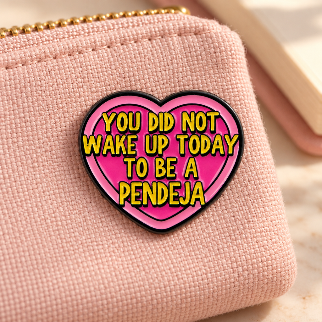 You Did Not Wake Up Today To Be A Pendeja enamel pin on a blush woven pouch